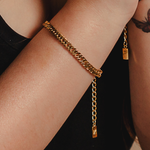 Closeup view of Leo Bracelet worn on wrist, showing its bold and sleek gold chain.