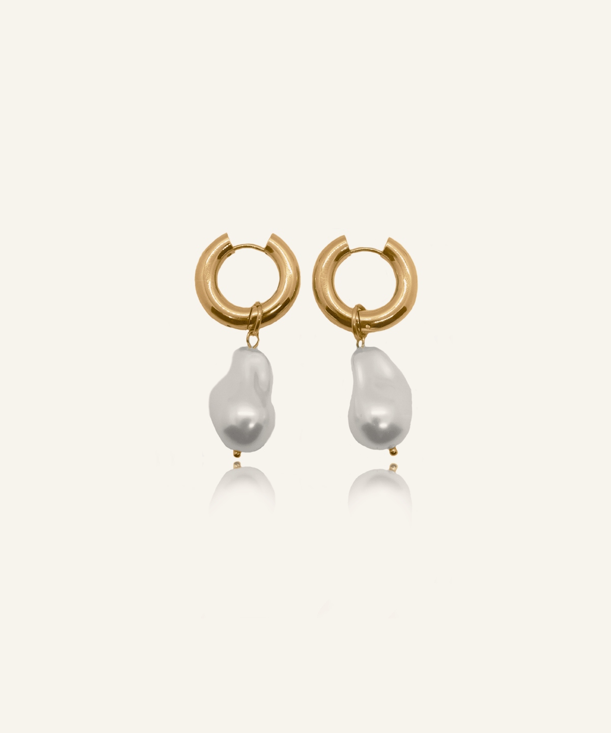 Flatlay image of Maya Earrings featuring gold hoops and baroque-style pearls.
