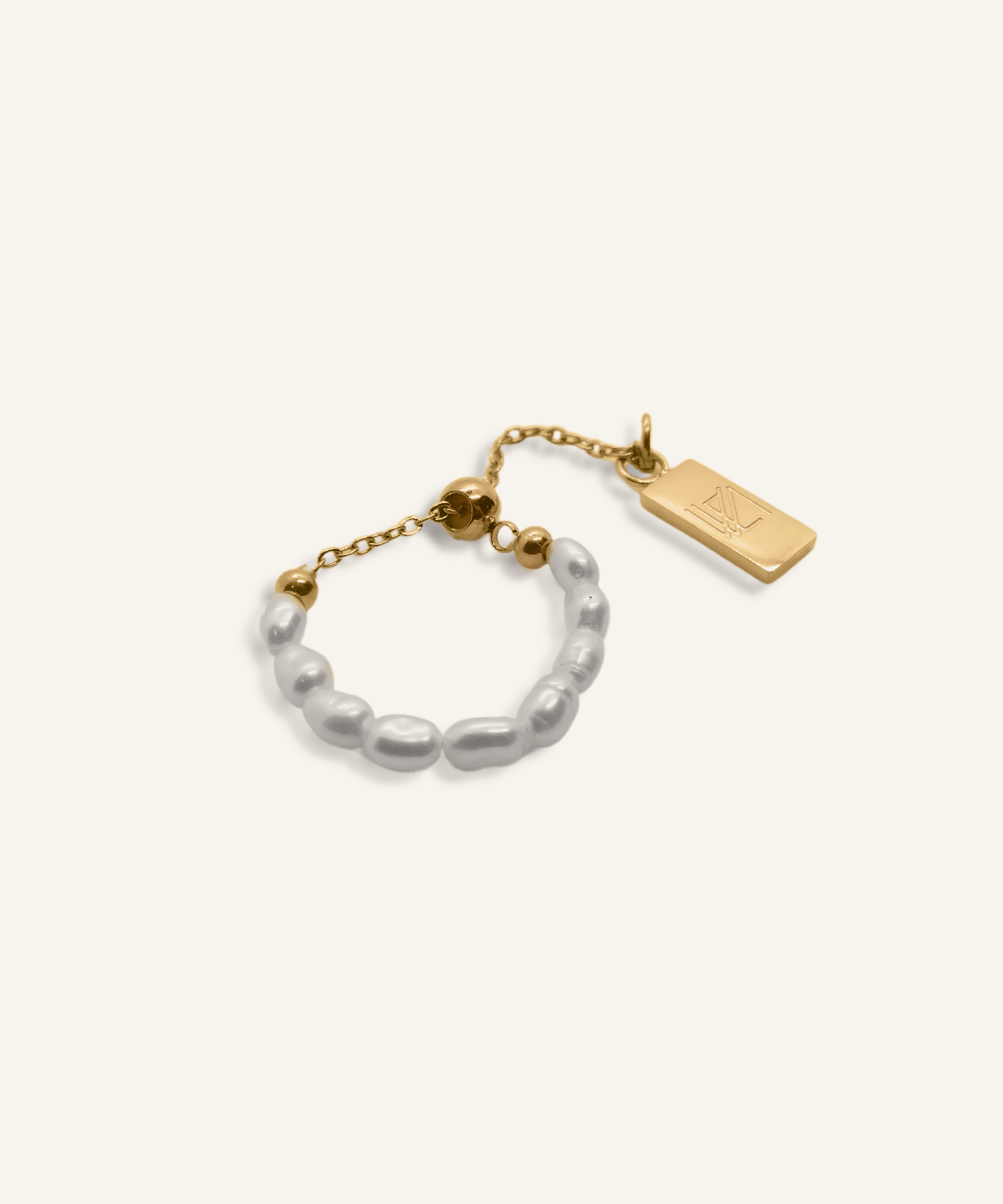 Neya Ring featuring a delicate pearl band with gold chain and accent charm.