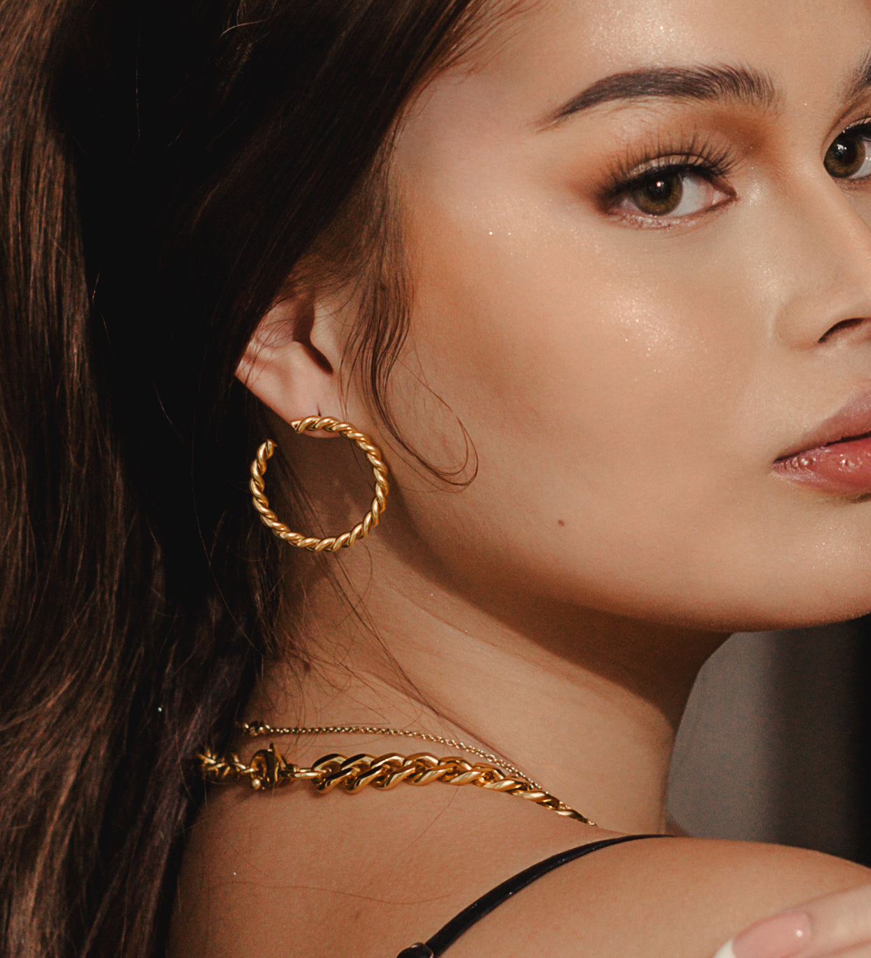 Closeup view of Selene Earrings worn, highlighting the twisted texture.