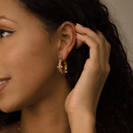 Side view of Tyla Earrings showing curved gold hoop with pearls and zirconia.