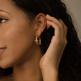 Side view of Tyla Earrings showing curved gold hoop with pearls and zirconia.