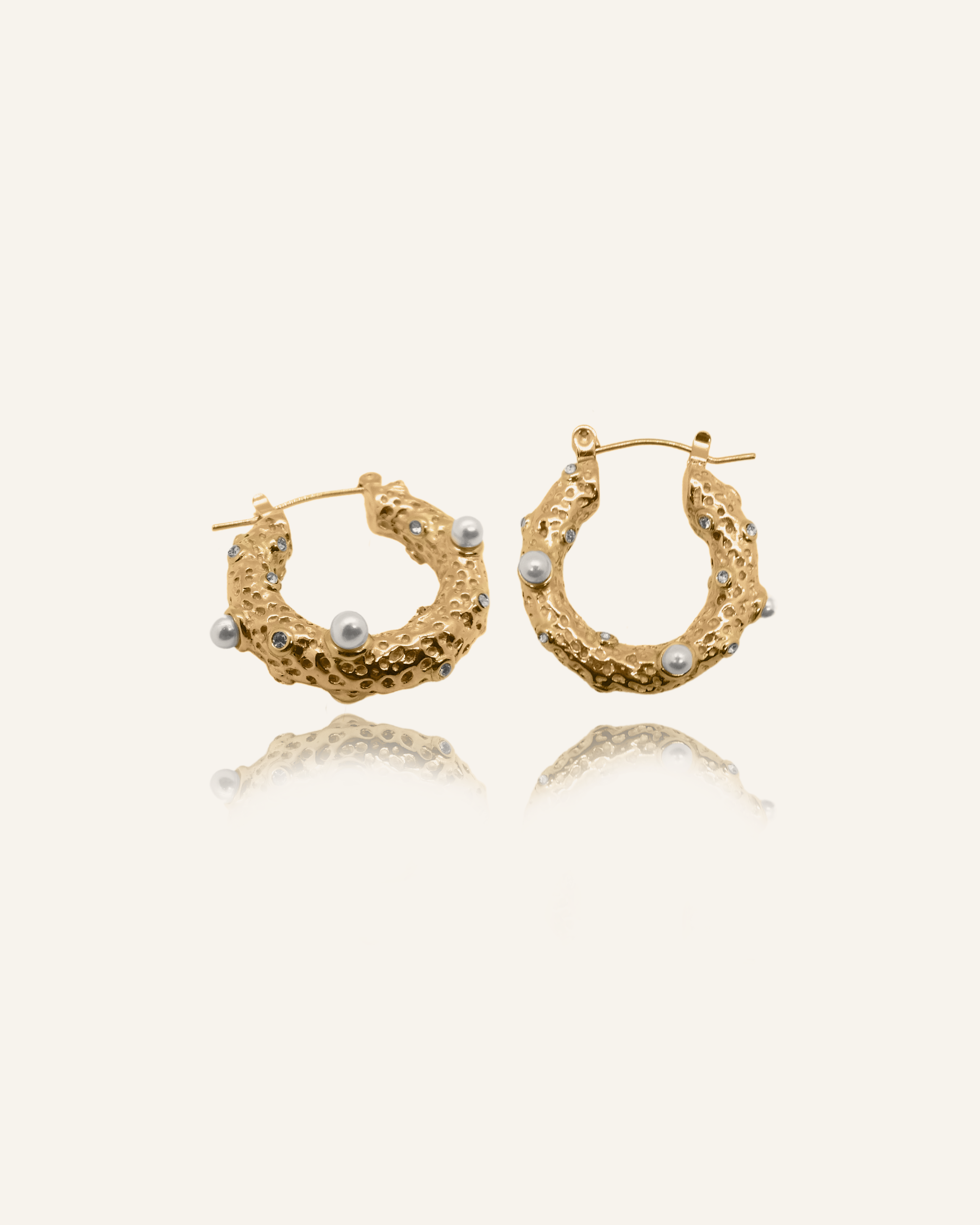 Tyla Earrings featuring freshwater pearls and white zirconia on gold hoops.