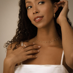 Tyla Earrings worn up to chest view, styled with gold-toned minimal jewelry.