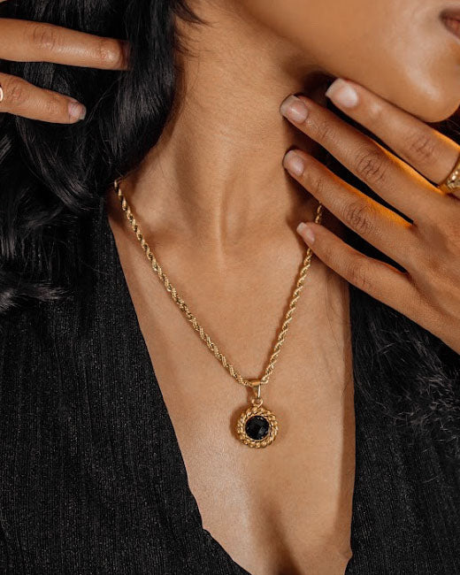 Closeup of the Valeriana Necklace worn, highlighting gold and onyx details.