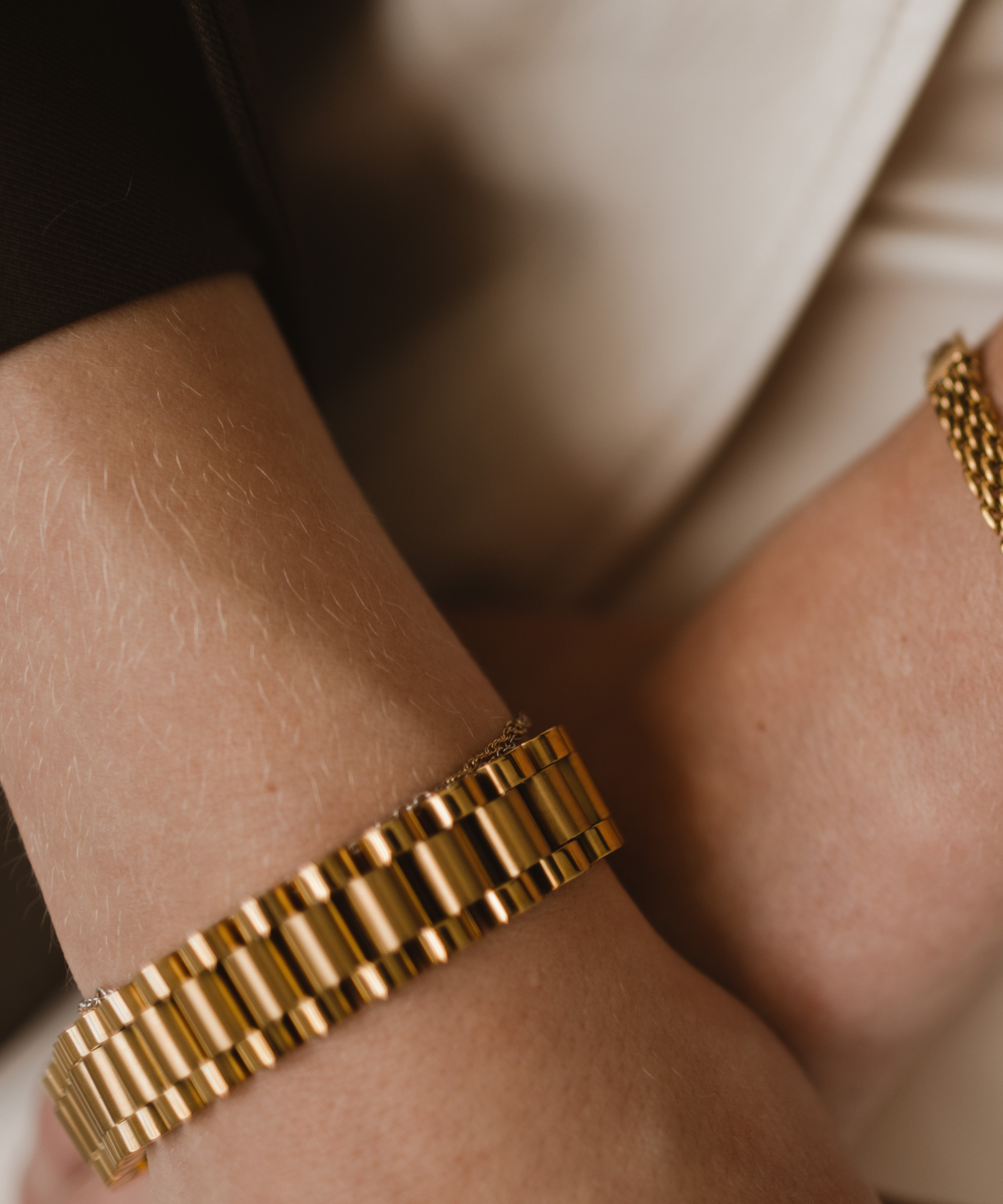 Zeus gold watchband bracelet worn on wrist with detailed watch link design.