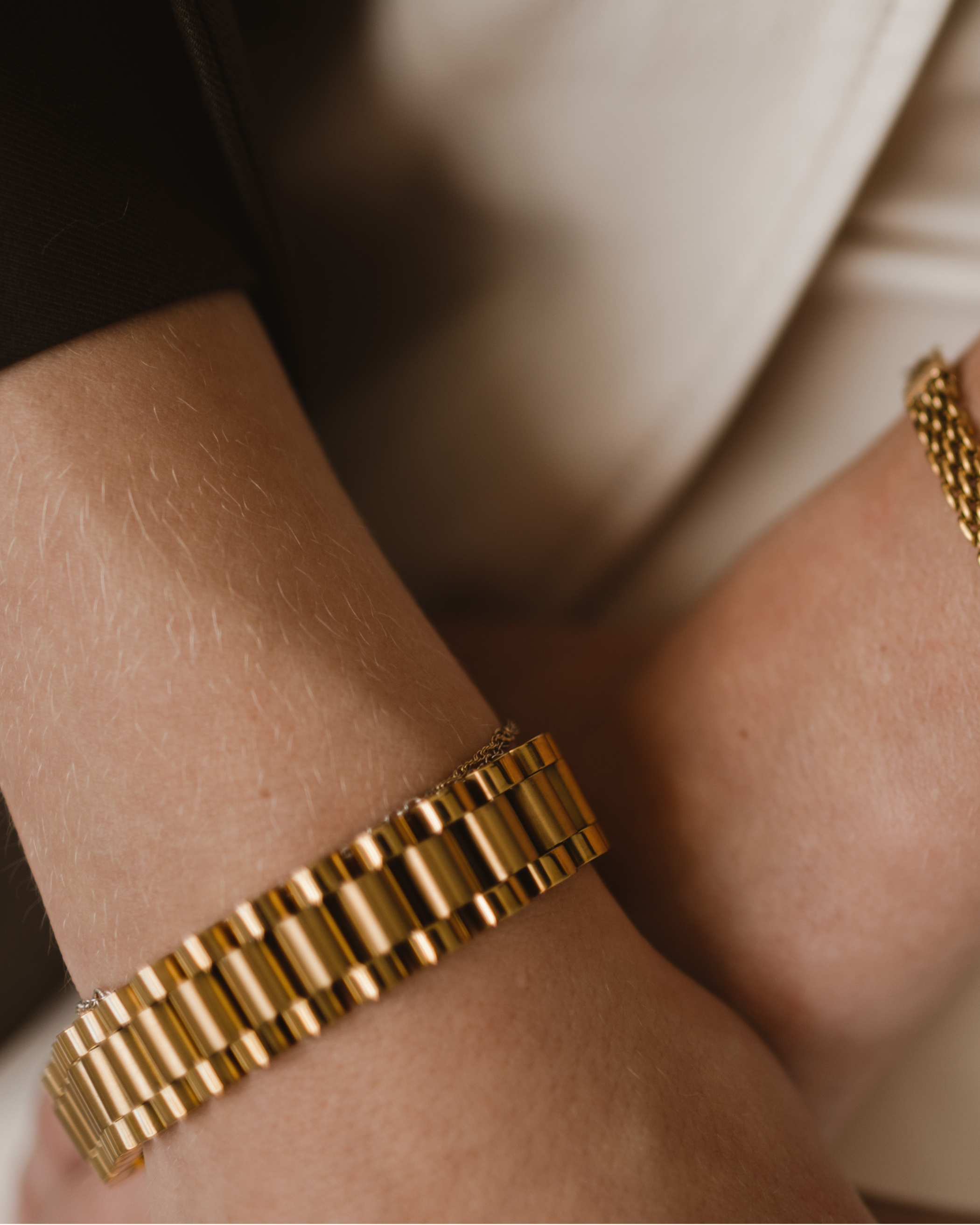 Zeus gold watchband bracelet worn on wrist with detailed watch link design.