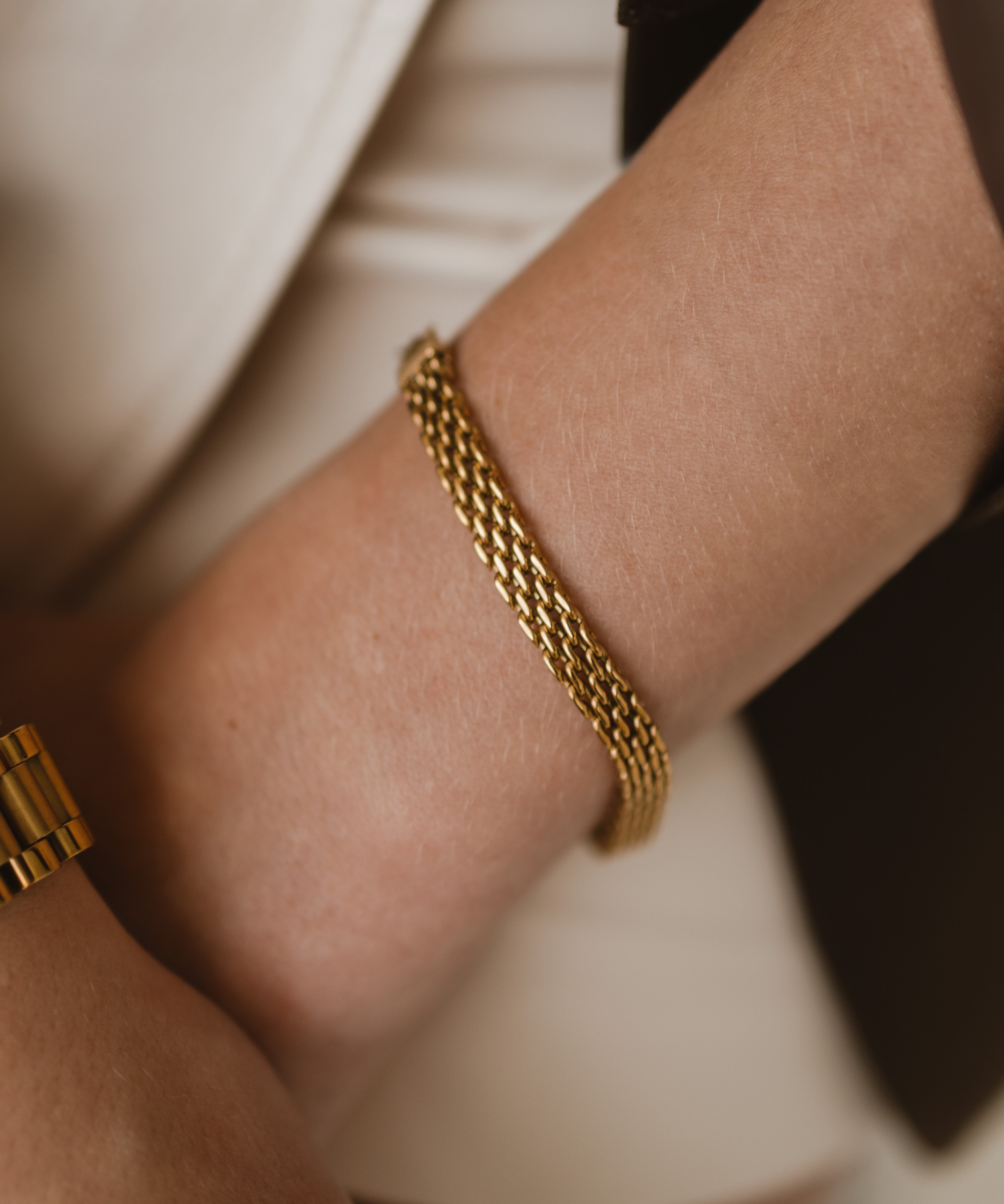 Close-up of Zuri Bracelet on wrist, highlighting its textured gold mesh design.