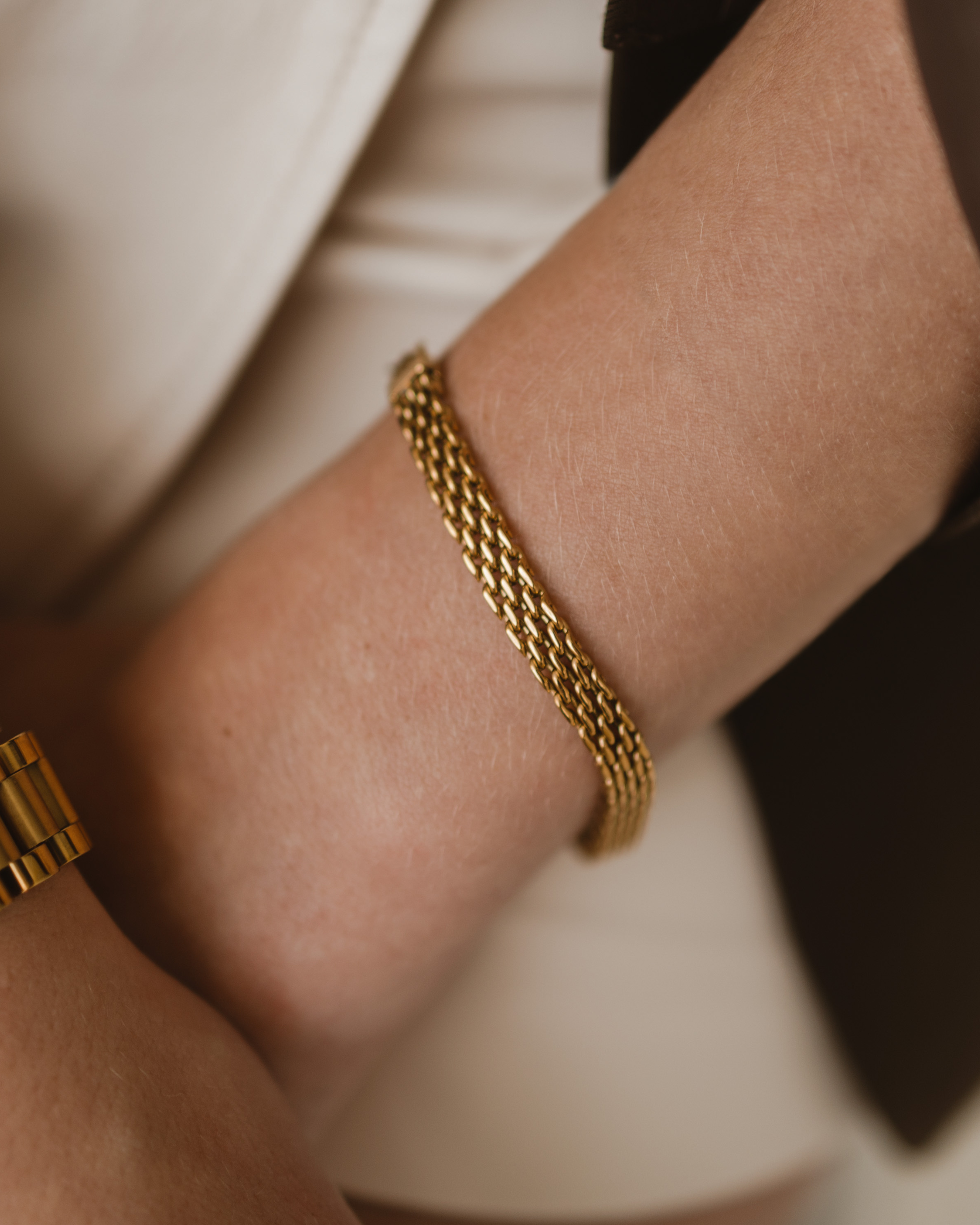 Close-up of Zuri Bracelet on wrist, highlighting its textured gold mesh design.